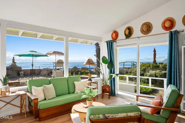a living room with furniture and a floor to ceiling window