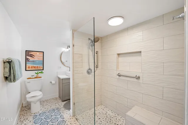 a bathroom with a toilet sink and shower