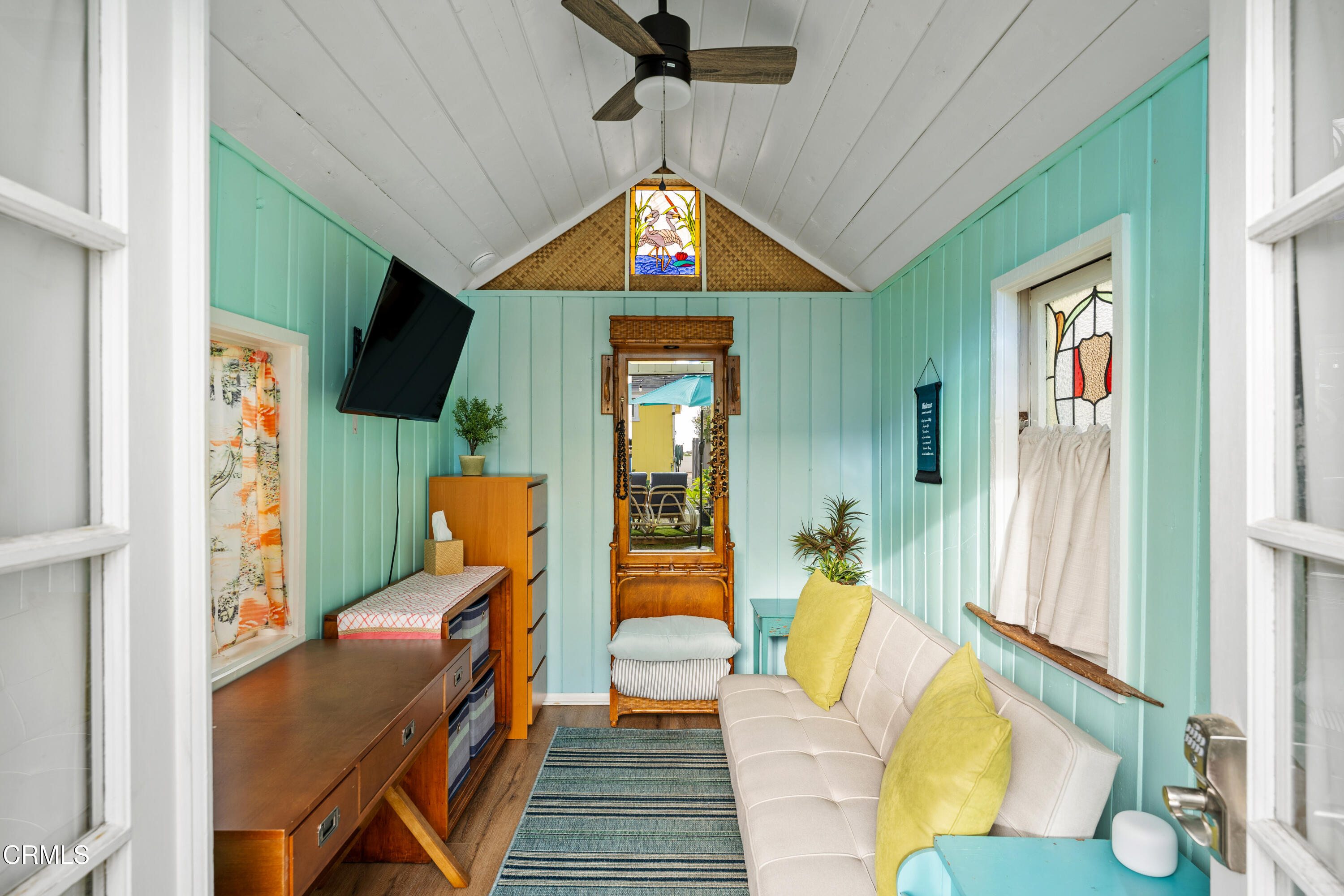 3048 Solimar Beach Drive Ventura, CA 93001 - Photo 24 of 35 a living room with furniture a flat screen tv and kitchen view