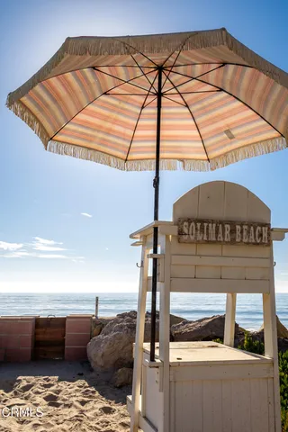 a roof deck with table and chairs