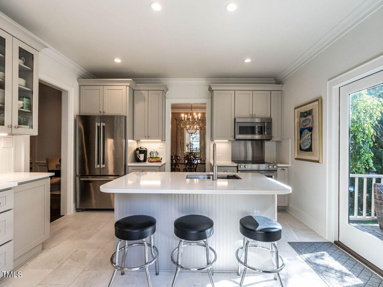 815 Marlowe Road, Unit 10 Raleigh, NC 27609 - Photo 11 of 28 a large kitchen with granite countertop a refrigerator a stove a sink counter space and dining table