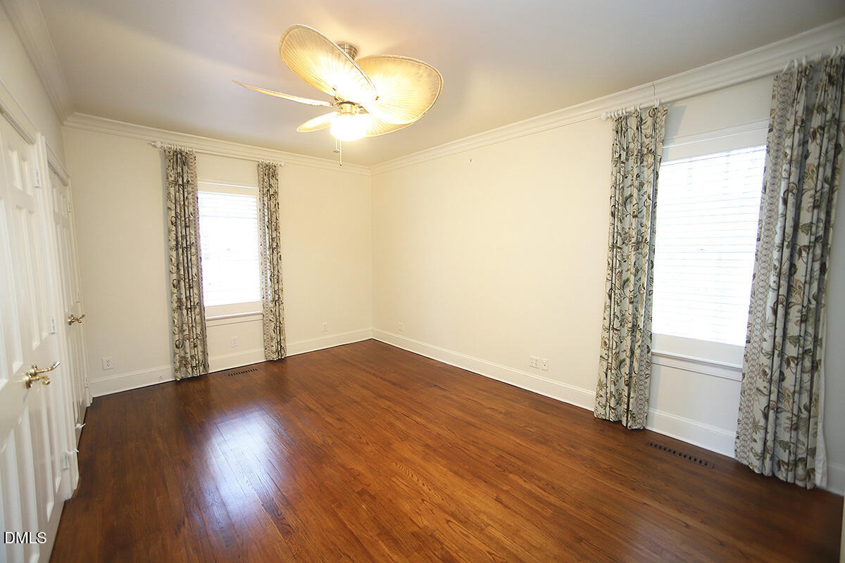 815 Marlowe Road, Unit 10 Raleigh, NC 27609 - Photo 13 of 28 a view of an empty room with wooden floor and a window