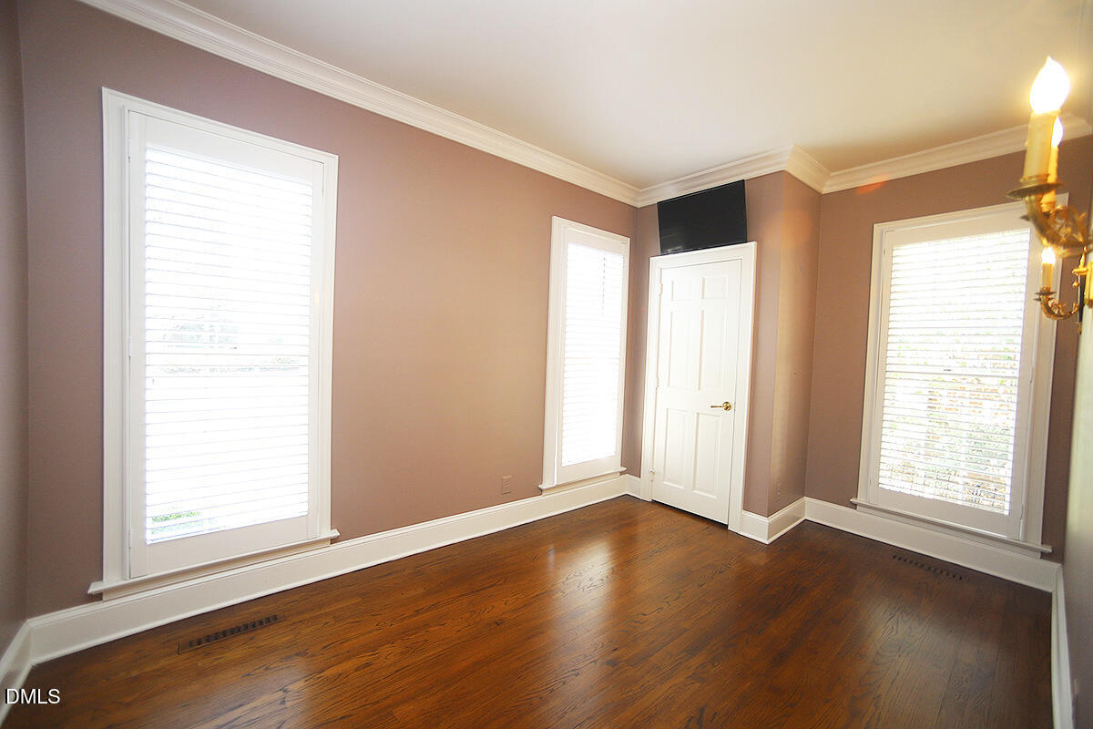 815 Marlowe Road, Unit 10 Raleigh, NC 27609 - Photo 15 of 28 an empty room with wooden floor and windows with curtains view