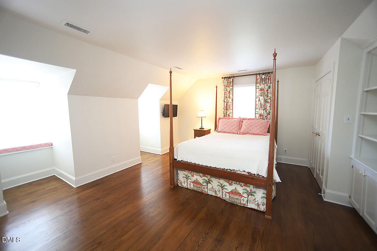 815 Marlowe Road, Unit 10 Raleigh, NC 27609 - Photo 16 of 28 a spacious bedroom with a bed and wooden floor