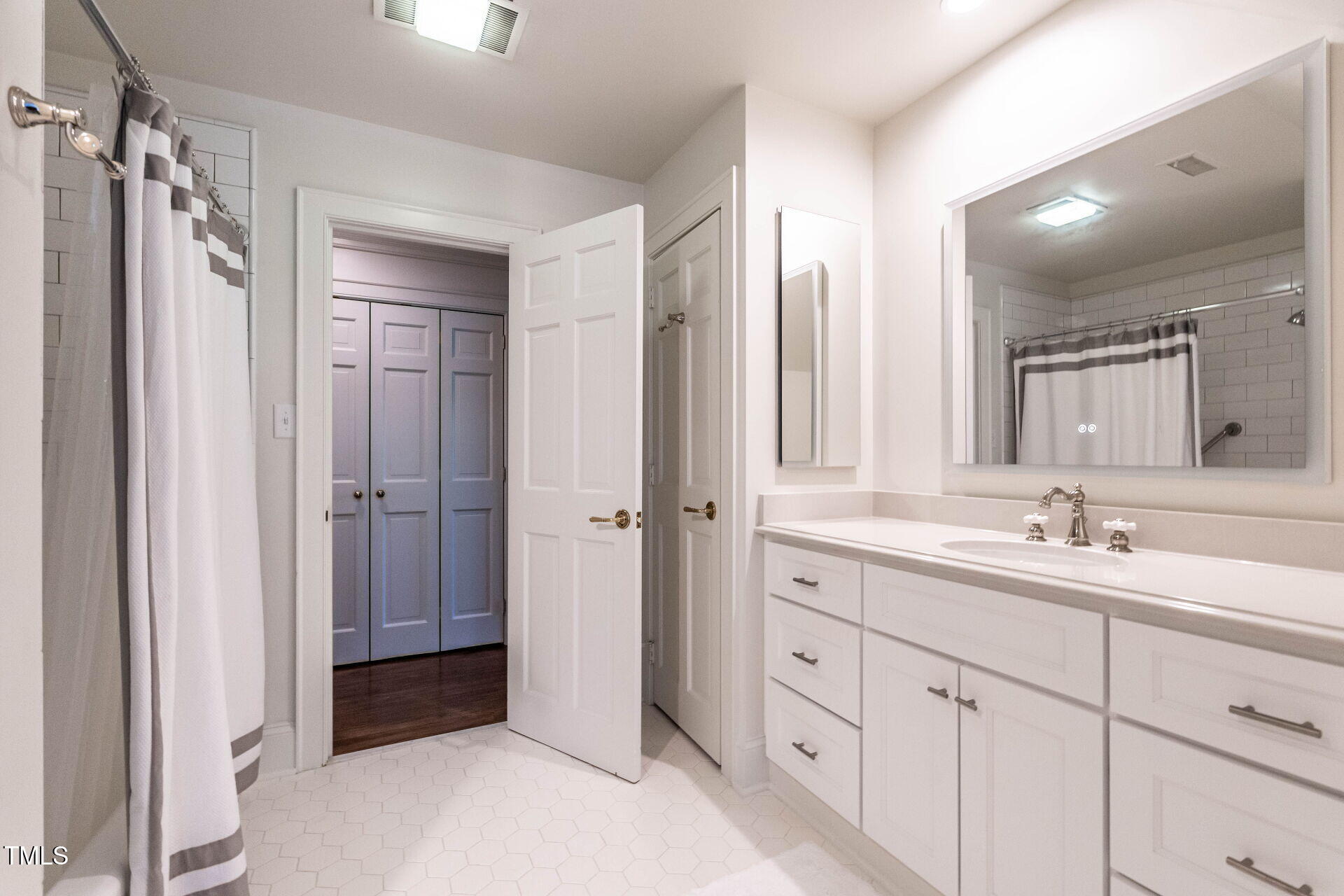 815 Marlowe Road, Unit 10 Raleigh, NC 27609 - Photo 18 of 28 a bathroom with a double vanity sink and mirror