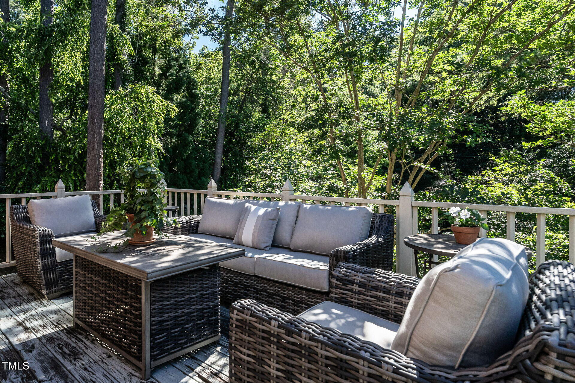 815 Marlowe Road, Unit 10 Raleigh, NC 27609 - Photo 20 of 28 a view of a patio with table and chairs potted plants and a large tree
