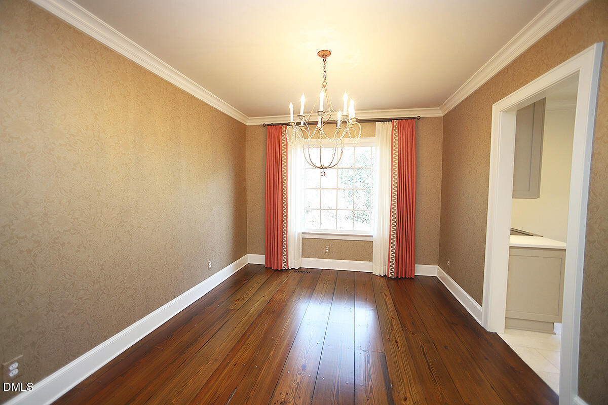 815 Marlowe Road, Unit 10 Raleigh, NC 27609 - Photo 8 of 28 a view of an empty room with wooden floor and a window