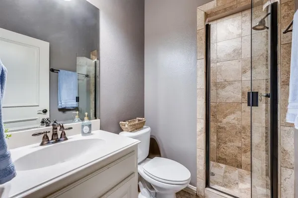 a bathroom with a sink toilet and shower