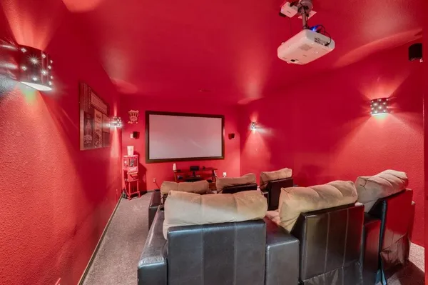 a room with furniture pool table flat screen tv and windows