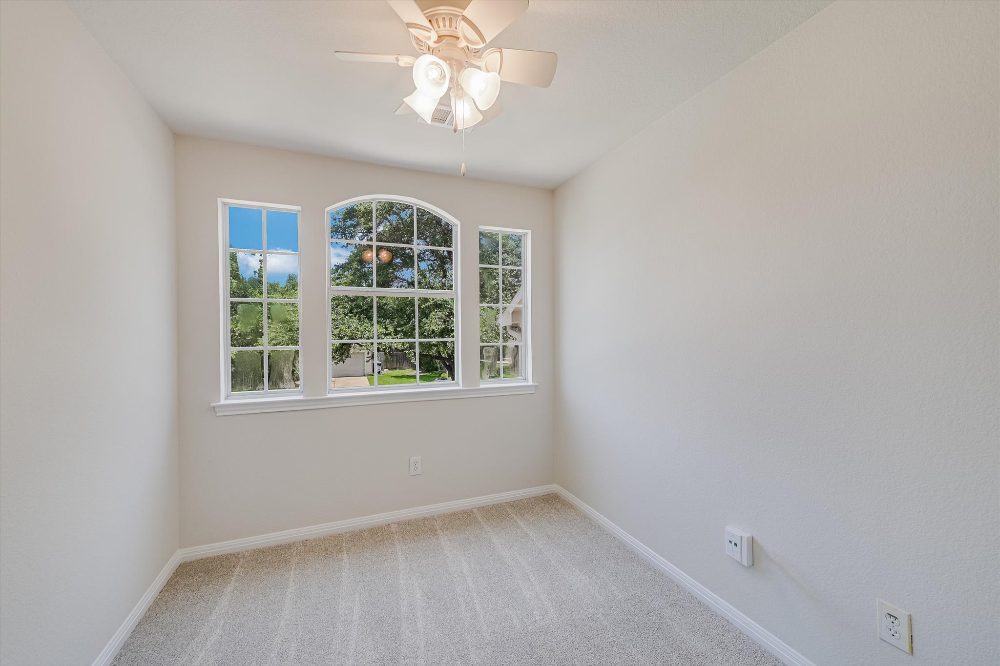 2849 Grimes Ranch Road Austin, TX 78732 - Photo 15 of 31 A well-lit bedroom with fresh carpet and architectural windows offers comfortable living.