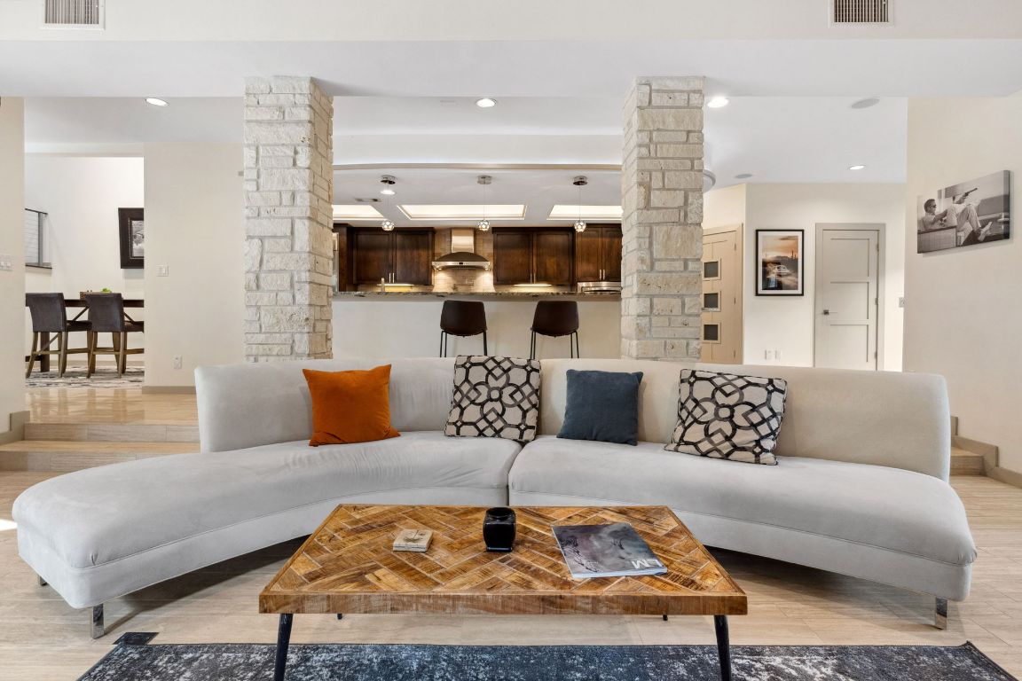 9 Swiftwater Trail The Hills, TX 78738 - Photo 11 of 34 Living area featuring light wood-style floors, recessed lighting, and decorative columns