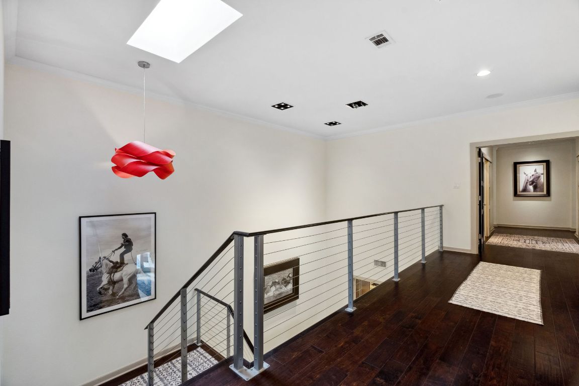 9 Swiftwater Trail The Hills, TX 78738 - Photo 16 of 34 Stairs with crown molding, a skylight, hardwood / wood-style floors, and recessed lighting