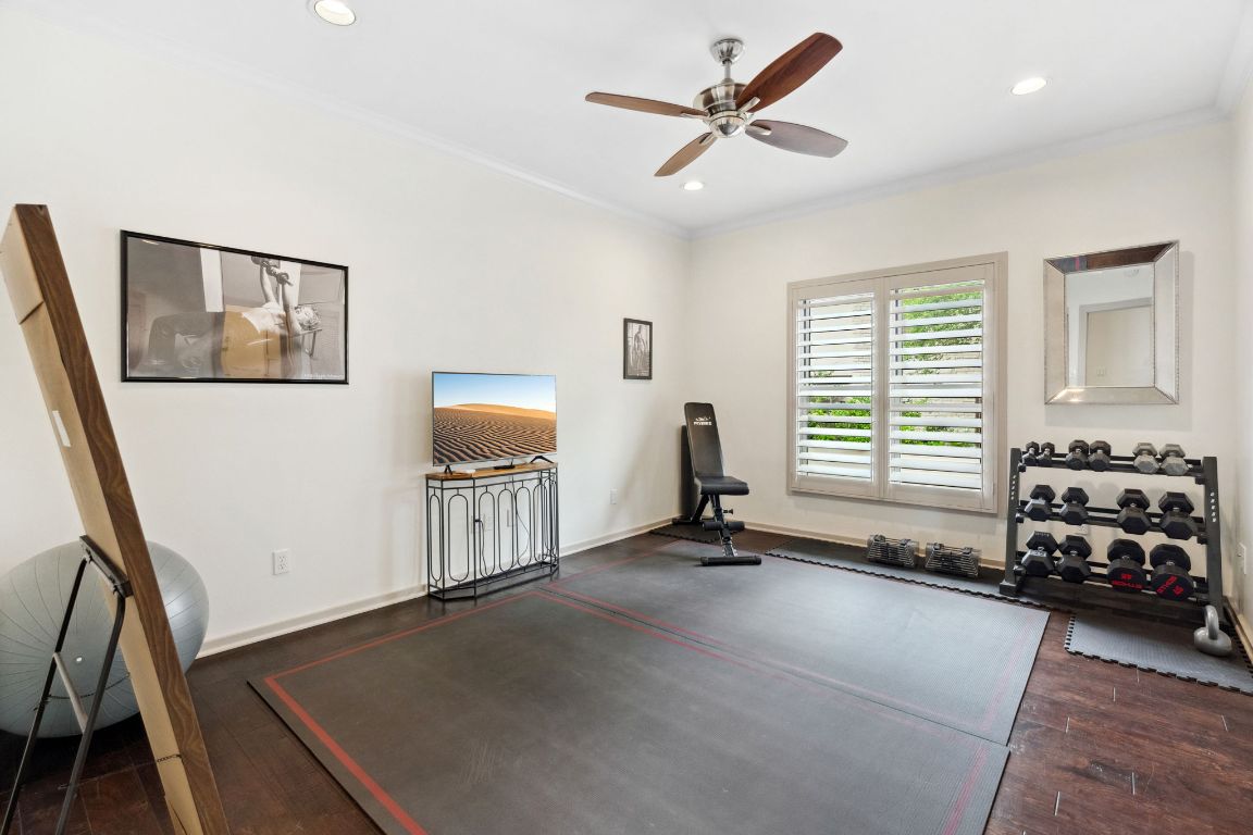 9 Swiftwater Trail The Hills, TX 78738 - Photo 29 of 34 Workout area with ornamental molding, dark wood-style flooring, recessed lighting, and ceiling fan
