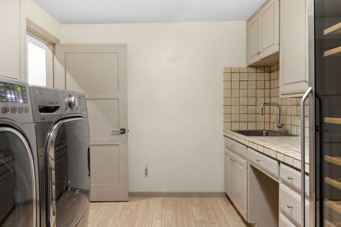 9 Swiftwater Trail The Hills, TX 78738 - Photo 31 of 34 Laundry room featuring cabinet space, separate washer and dryer, and light wood-style floors