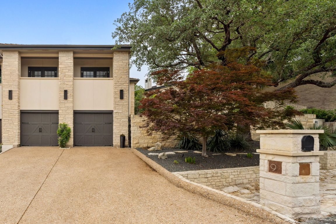 9 Swiftwater Trail The Hills, TX 78738 - Photo 34 of 34 View of front facade featuring concrete driveway, a garage, and stone siding
