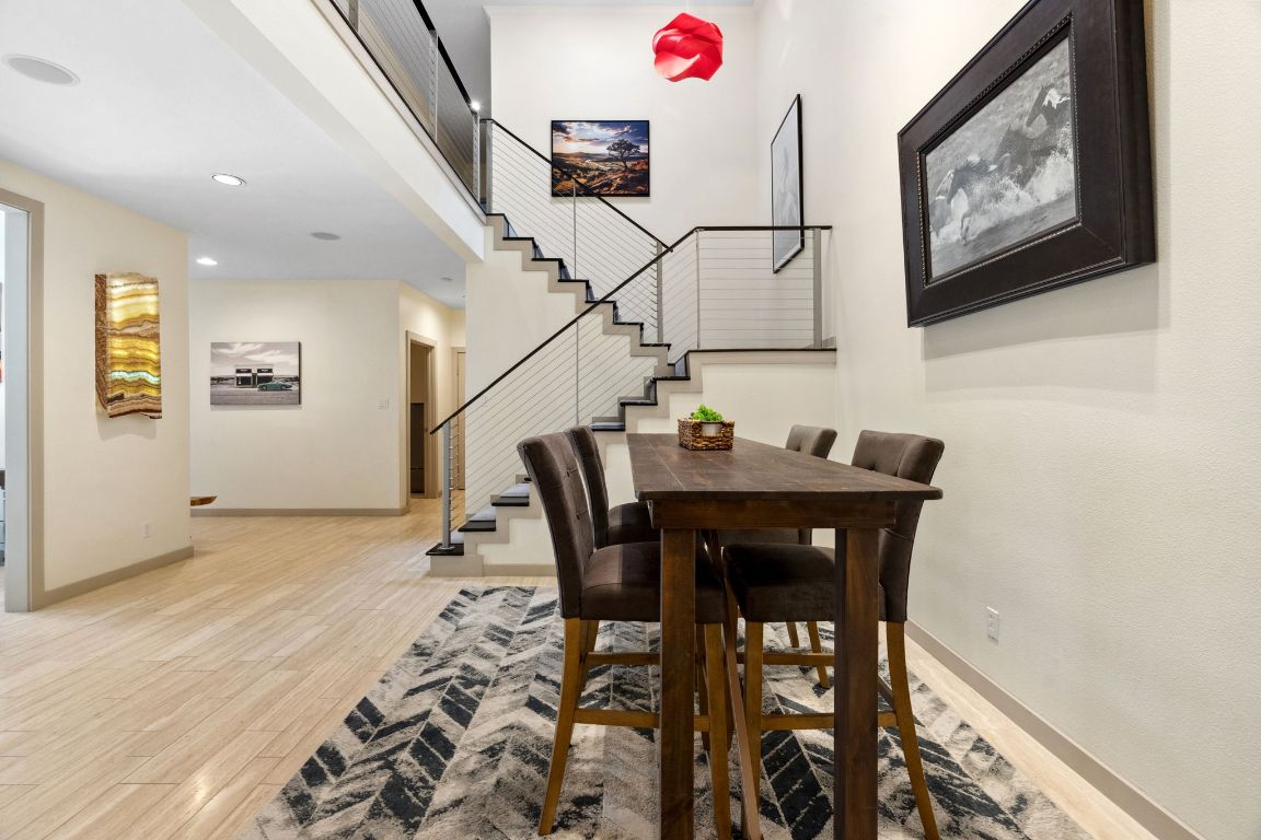 9 Swiftwater Trail The Hills, TX 78738 - Photo 4 of 34 Dining area with light wood-style flooring, recessed lighting, and stairs