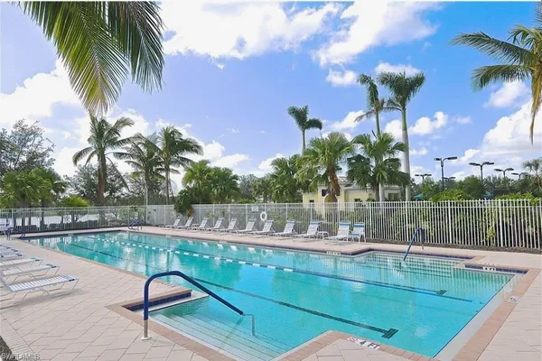 a view of swimming pool with a table and chairs