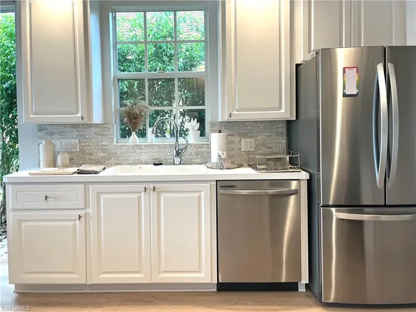 a kitchen with appliances cabinets and a sink