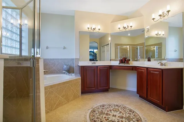 a spacious bathroom with a granite countertop sink and a mirror