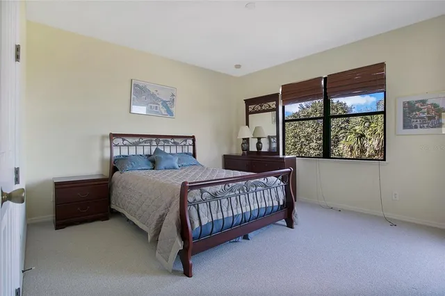 a bedroom with a bed lamp and window