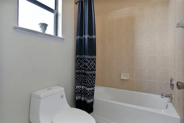 a bathroom with a toilet and a bathtub