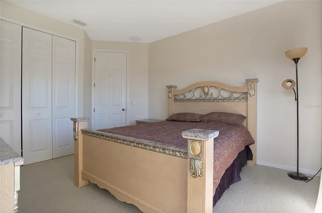 a bedroom with a bed and a closet