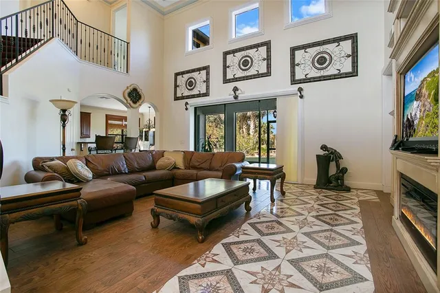 a living room with furniture a rug and a flat screen tv