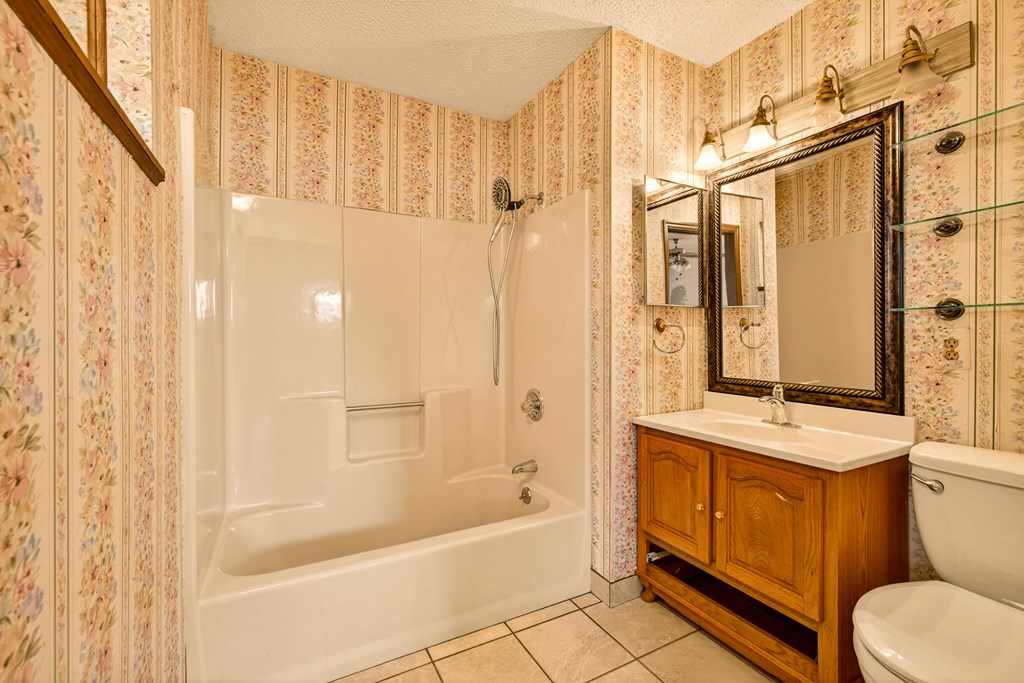 951 McClure Road Hayesville, NC 28904 - Photo 17 of 45 a bathroom with a granite countertop sink a toilet and shower