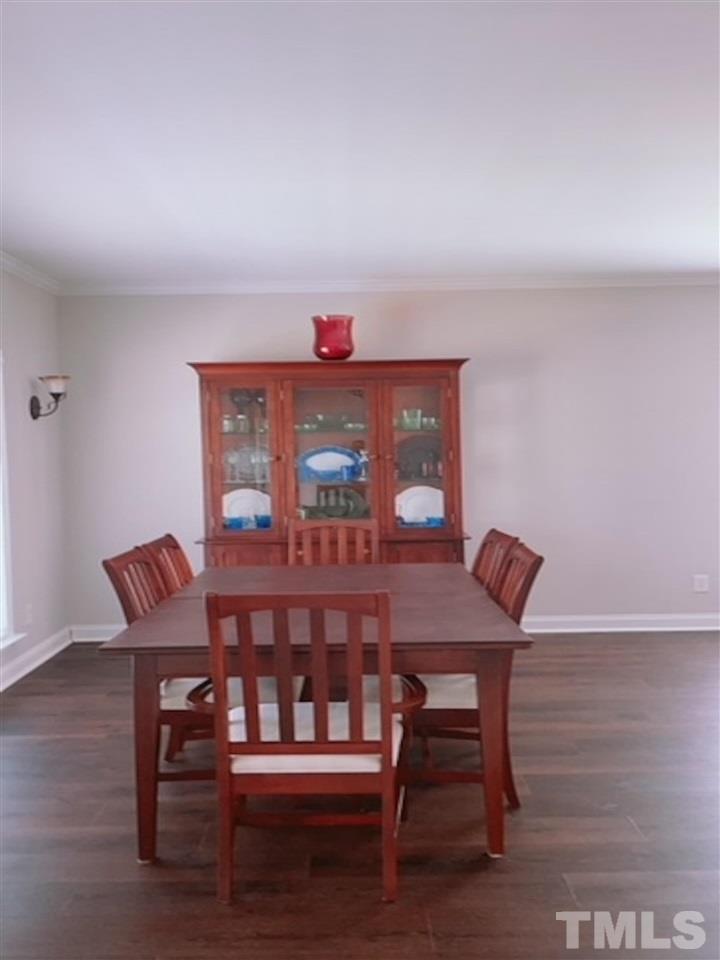 407 Challenge Road Raleigh, NC 27603 - Photo 13 of 29 a view of a dining room with furniture and wooden floor