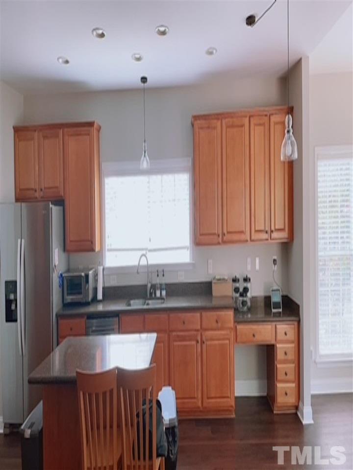 407 Challenge Road Raleigh, NC 27603 - Photo 16 of 29 a kitchen with granite countertop a sink a counter space and cabinets