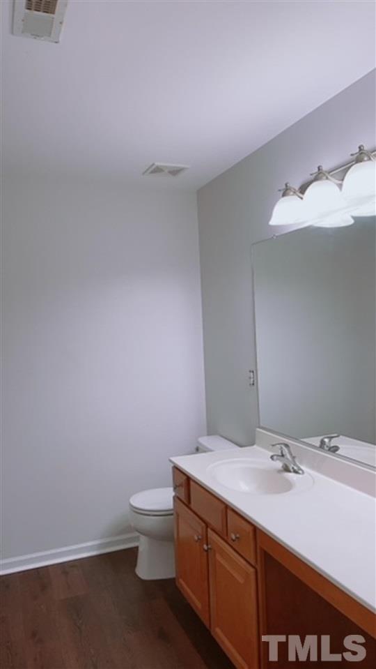 407 Challenge Road Raleigh, NC 27603 - Photo 18 of 29 a bathroom with a sink and a toilet