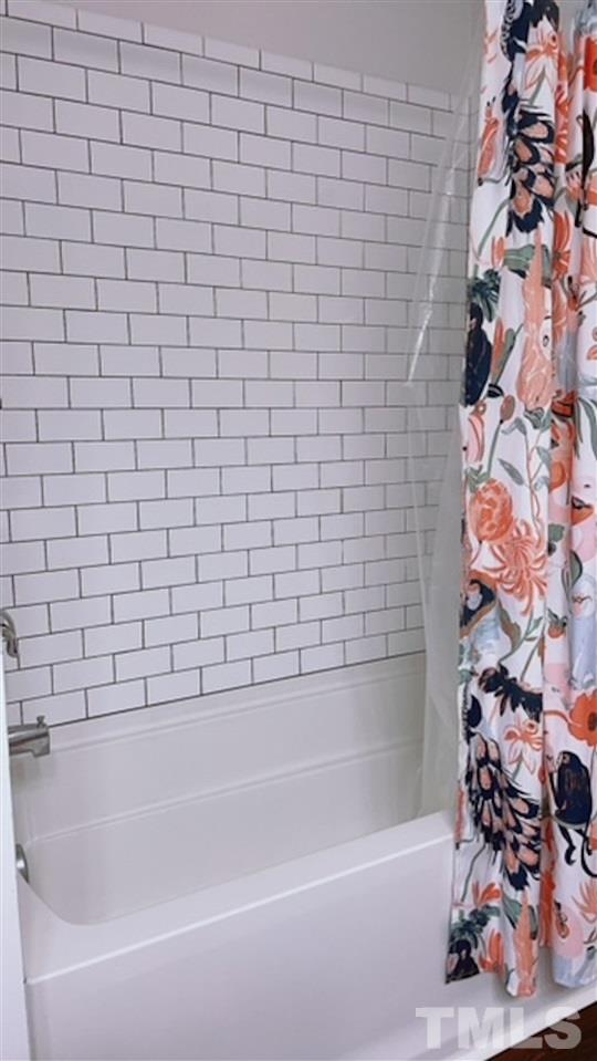 407 Challenge Road Raleigh, NC 27603 - Photo 19 of 29 a bathroom with a bathtub and shower