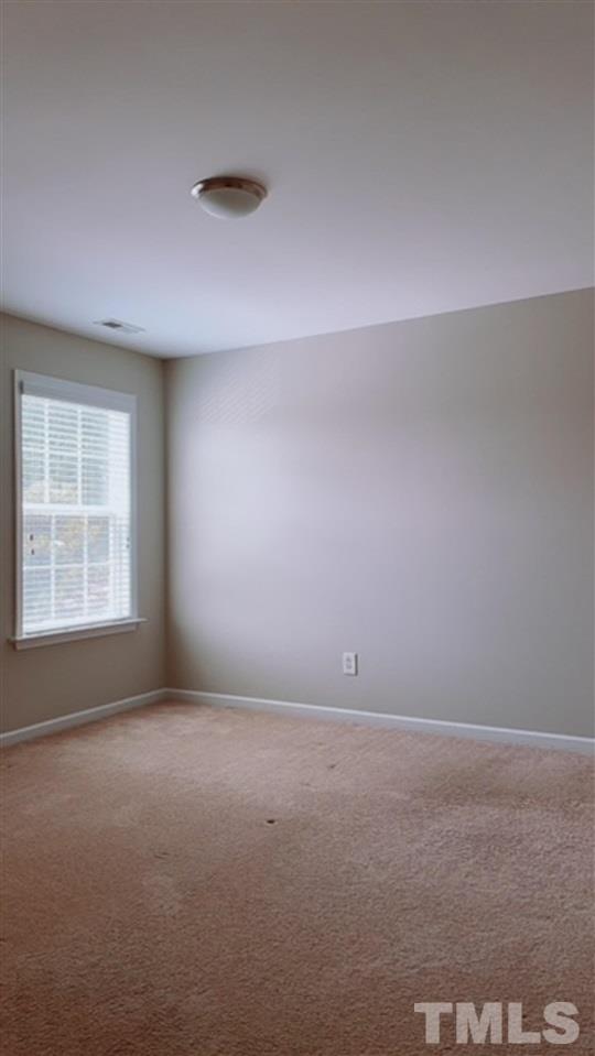 407 Challenge Road Raleigh, NC 27603 - Photo 21 of 29 an empty room with a window