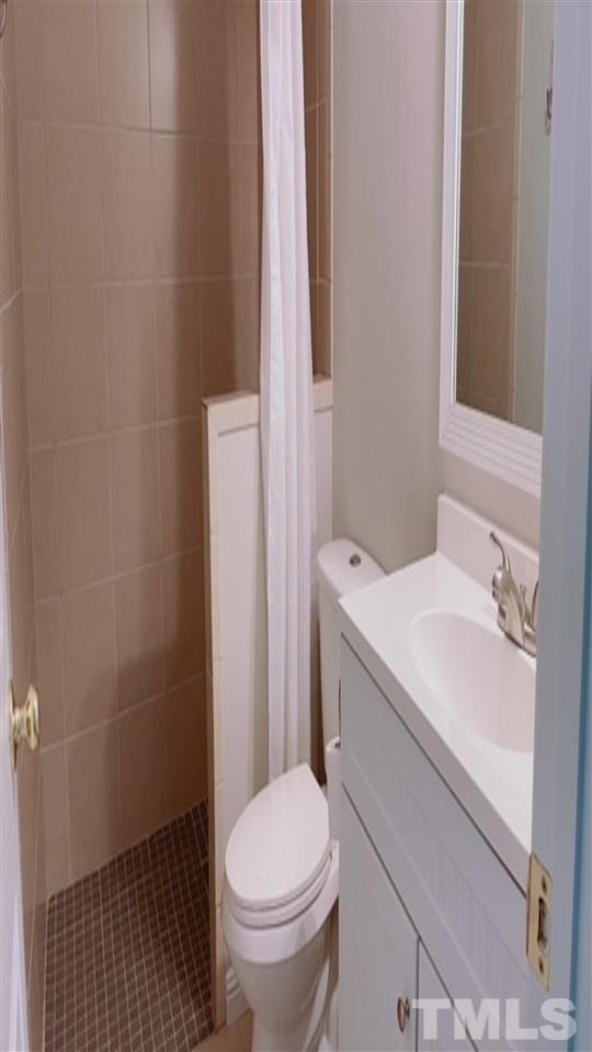 407 Challenge Road Raleigh, NC 27603 - Photo 22 of 29 a bathroom with a sink toilet and shower
