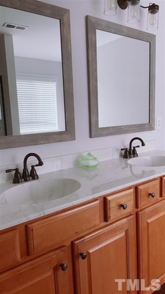 407 Challenge Road Raleigh, NC 27603 - Photo 24 of 29 a bathroom with a sink and a mirror