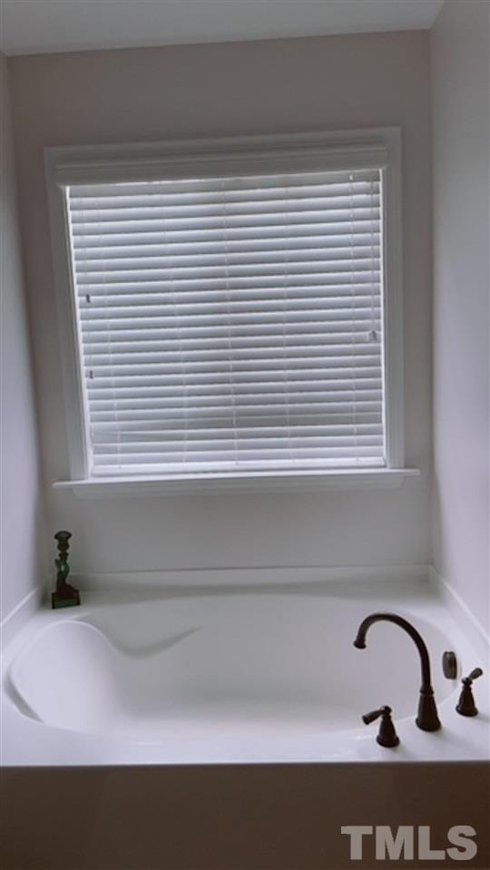 407 Challenge Road Raleigh, NC 27603 - Photo 26 of 29 a bathroom with a sink and a window