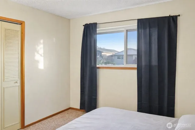 a view of hallway with furniture and a window