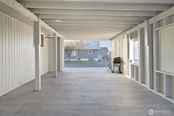 a view of hallway with furniture and a window