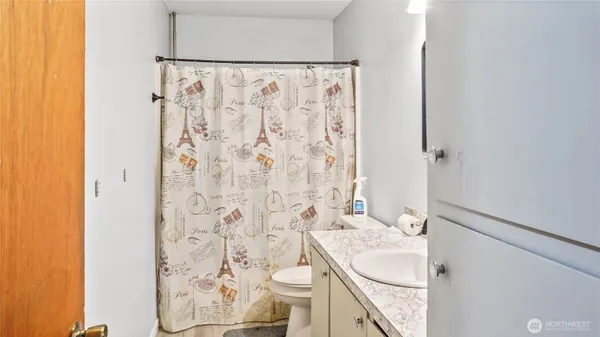 a bathroom with a sink and a shower curtain