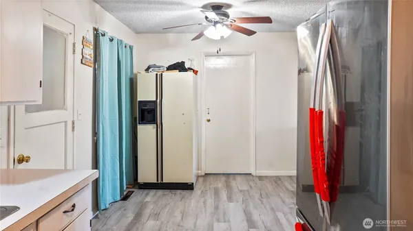 a view of a kitchen with a refrigerator and a sink