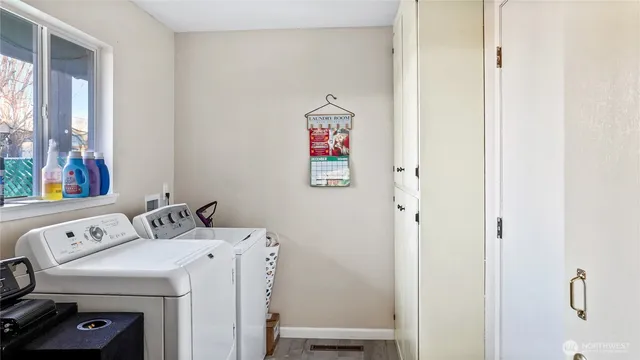 an empty room with windows and ceiling fan
