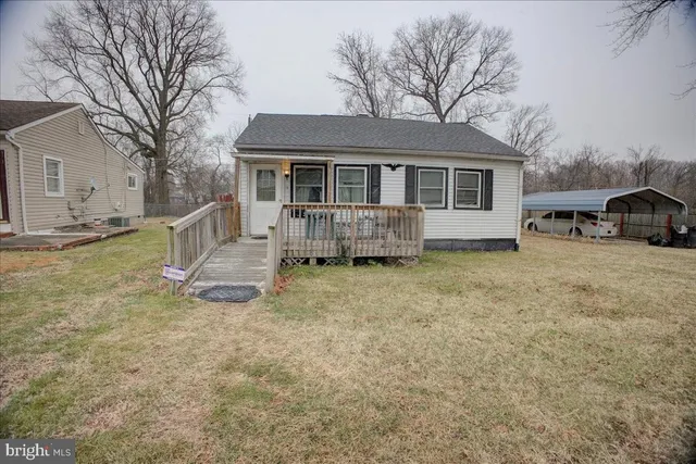 a view of a house with a yard and sitting area