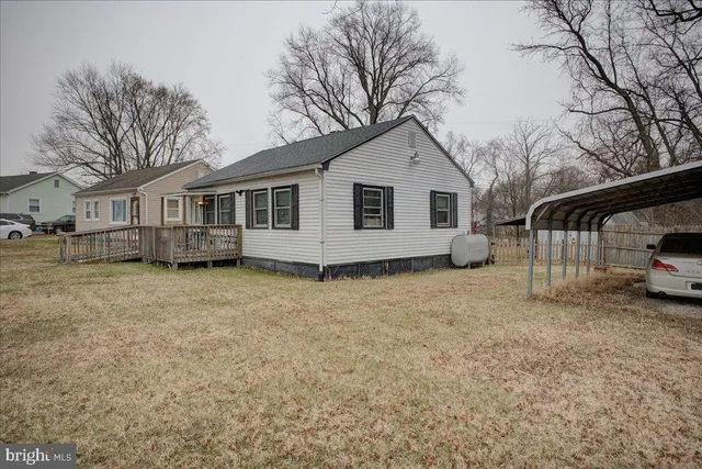 a view of a house with a backyard and trees