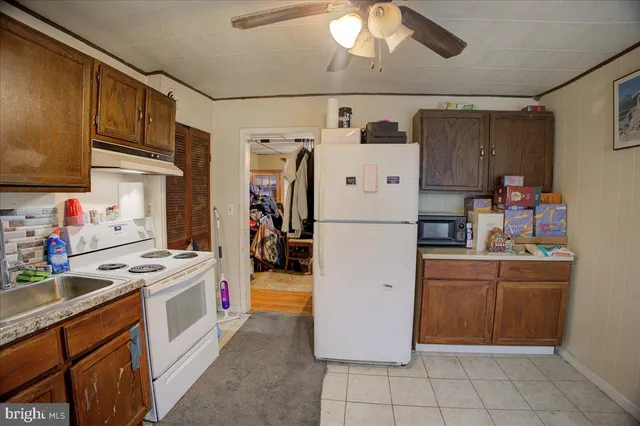 a kitchen with refrigerator and cabinets
