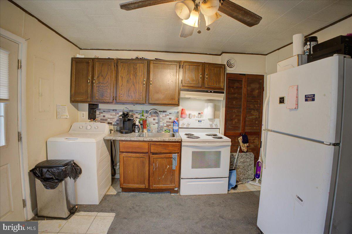 16 Taxi Way Middle River, MD 21220 - Photo 5 of 16 a kitchen with a refrigerator and a sink