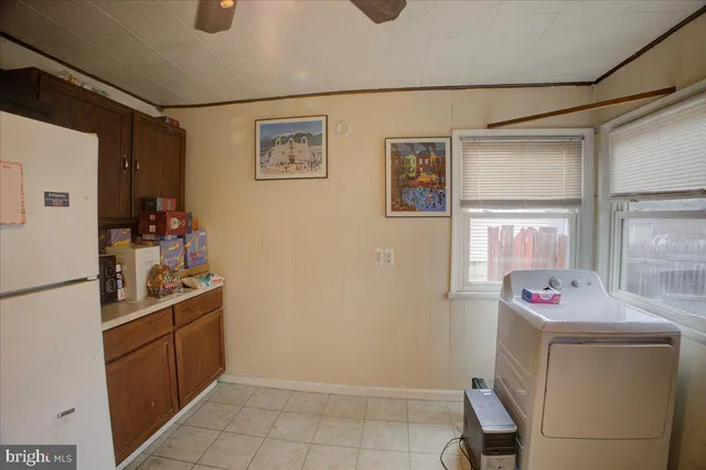 a utility room with cabinets washer and dryer