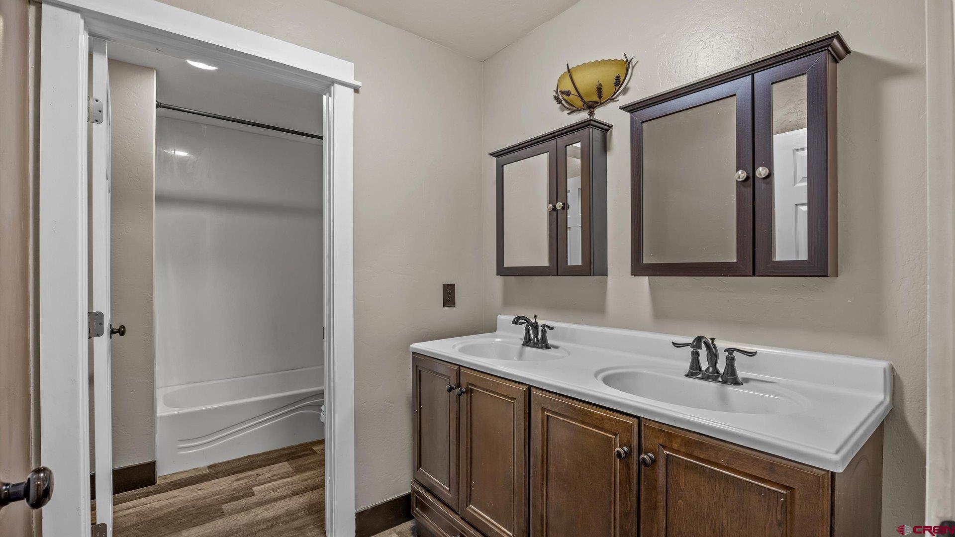 9097 2150th Road Austin, CO 81410 - Photo 18 of 19 a bathroom with a sink double vanity and a mirror