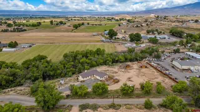 an aerial view of beach and residential houses with outdoor space