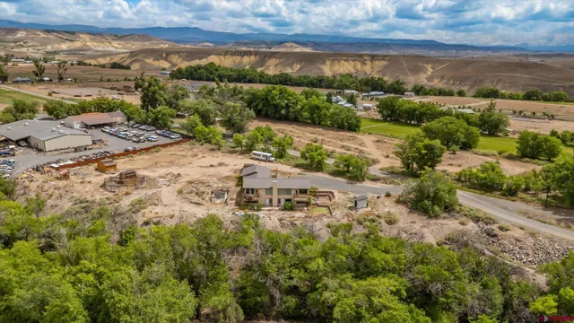an aerial view of a house with a mountain