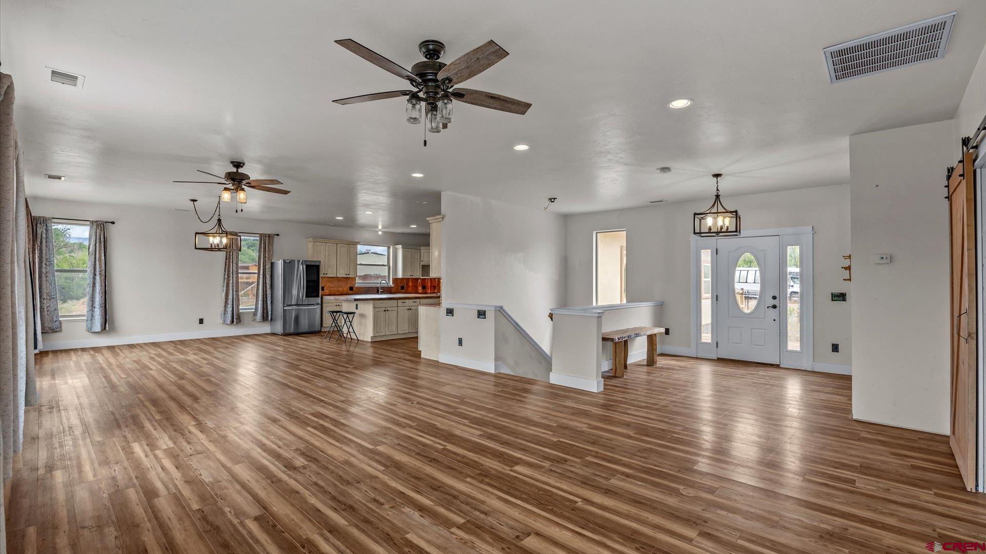 9097 2150th Road Austin, CO 81410 - Photo 5 of 19 a view of a living room and kitchen with furniture wooden floor and a ceiling fan